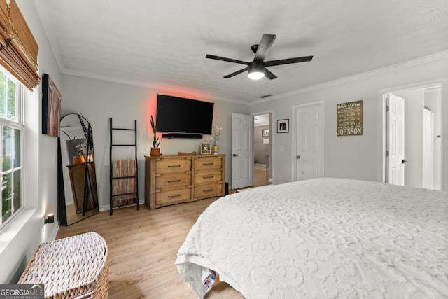 7277 Plum Creek Dr, Gainesville, GA 30507 - bedroom featuring light wood-style floors, a textured ceiling, ornamental molding, ceiling fan, and baseboards