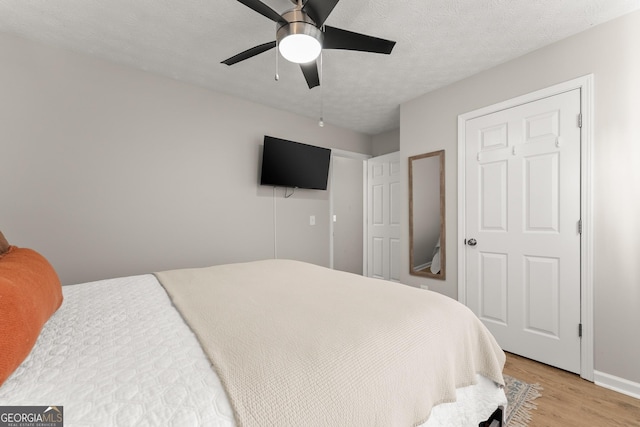 7277 Plum Creek Dr, Gainesville, GA 30507 - bedroom with light wood finished floors, baseboards, and ceiling fan