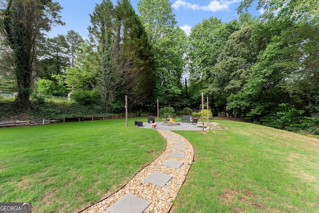 7277 Plum Creek Dr, Gainesville, GA 30507 - view of grassy yard with a fire pit and a patio area