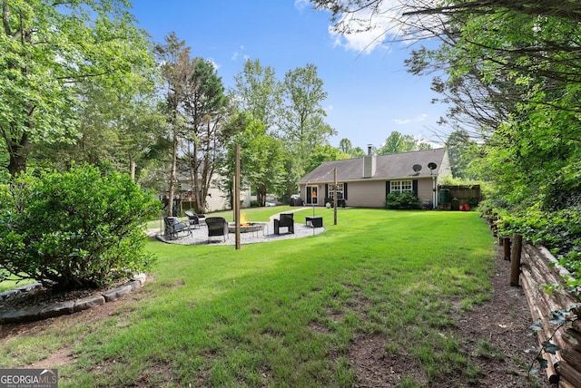7277 Plum Creek Dr, Gainesville, GA 30507 - view of green lawn with an outdoor fire pit and a patio area