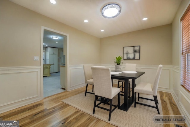 2436 Green Hollow Ct, Conyers, GA 30012 - dining room featuring wainscoting, wood finished floors, recessed lighting, and a decorative wall