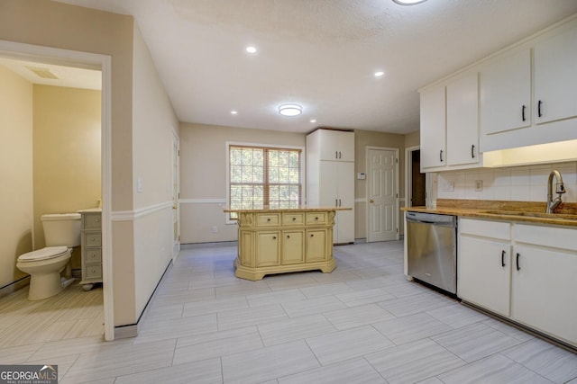2436 Green Hollow Ct, Conyers, GA 30012 - kitchen featuring dishwasher, a sink, backsplash, recessed lighting, and white cabinetry