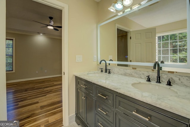 2436 Green Hollow Ct, Conyers, GA 30012 - bathroom featuring double vanity, wood finished floors, baseboards, ceiling fan, and crown molding