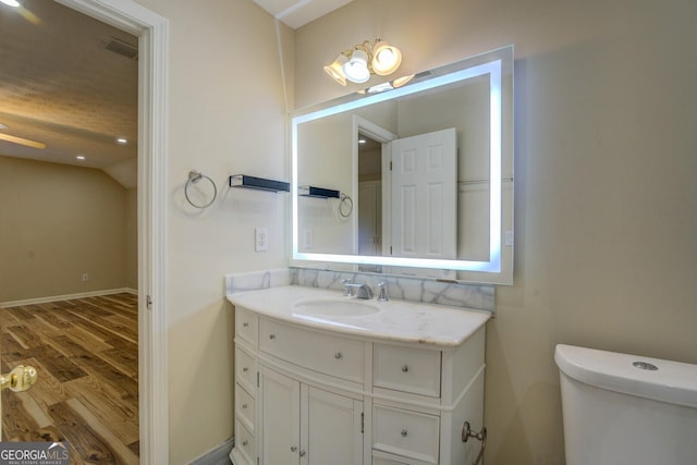 2436 Green Hollow Ct, Conyers, GA 30012 - bathroom featuring wood finished floors, vanity, toilet, and lofted ceiling