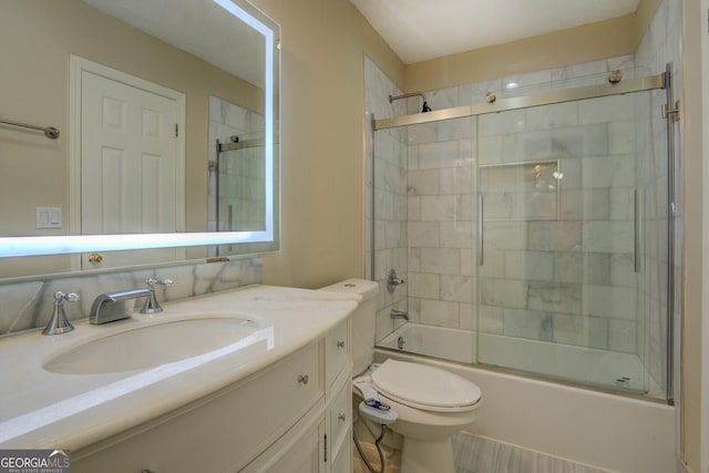 2436 Green Hollow Ct, Conyers, GA 30012 - bathroom with toilet, vanity, and shower / bath combination with glass door