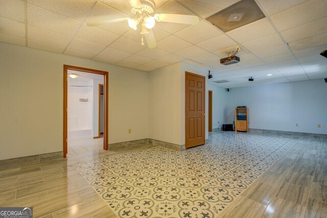 2436 Green Hollow Ct, Conyers, GA 30012 - empty room featuring ceiling fan, a paneled ceiling, baseboards, and light wood-type flooring