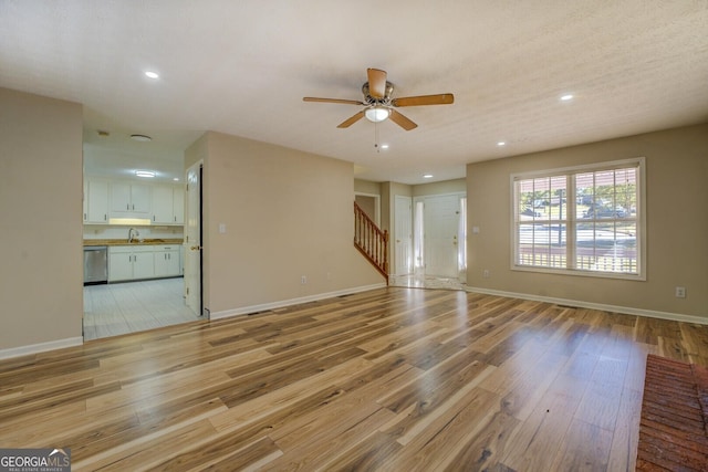 2436 Green Hollow Ct, Conyers, GA 30012 - unfurnished living room featuring stairs, ceiling fan, light wood finished floors, recessed lighting, and baseboards