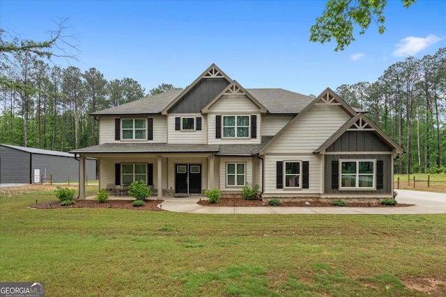 337 Paynes Lake Rd, Carrollton, GA 30116 - craftsman-style home featuring covered porch, a front lawn, board and batten siding, and a shingled roof