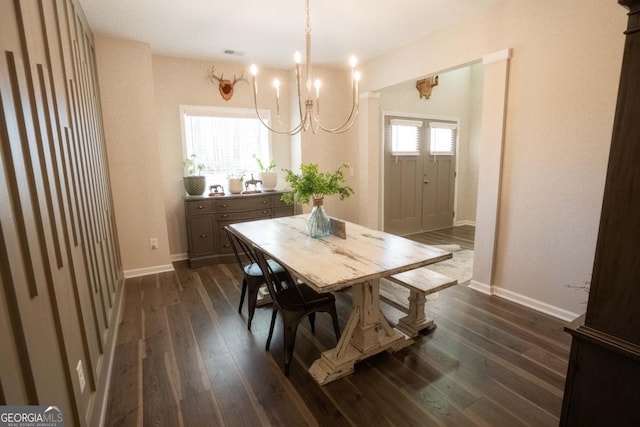 337 Paynes Lake Rd, Carrollton, GA 30116 - dining space featuring a chandelier, dark wood-type flooring, and baseboards