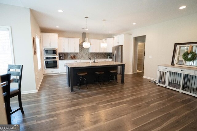 337 Paynes Lake Rd, Carrollton, GA 30116 - kitchen with stainless steel appliances, dark wood-type flooring, white cabinets, decorative backsplash, and recessed lighting