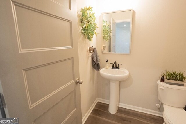 337 Paynes Lake Rd, Carrollton, GA 30116 - bathroom with toilet, wood finished floors, baseboards, and a sink