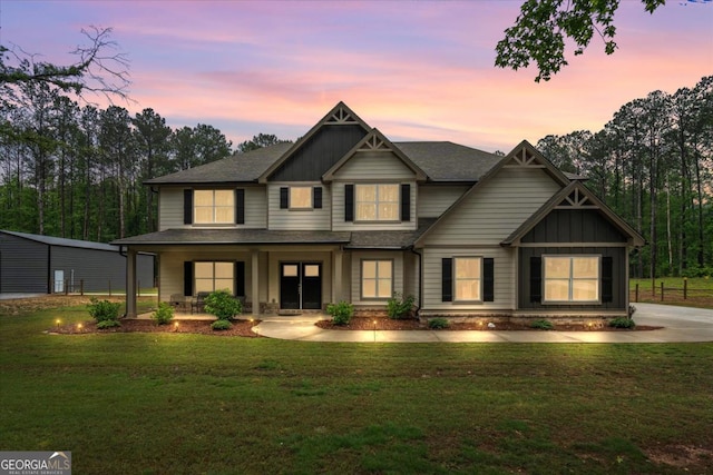 337 Paynes Lake Rd, Carrollton, GA 30116 - craftsman inspired home featuring board and batten siding, a front yard, covered porch, and roof with shingles
