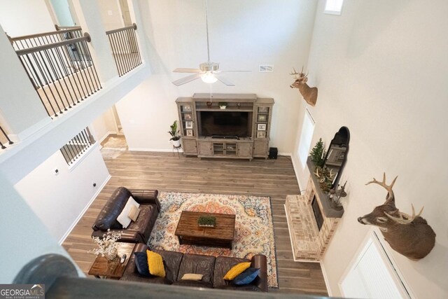 337 Paynes Lake Rd, Carrollton, GA 30116 - living area with ceiling fan, wood finished floors, a towering ceiling, and baseboards