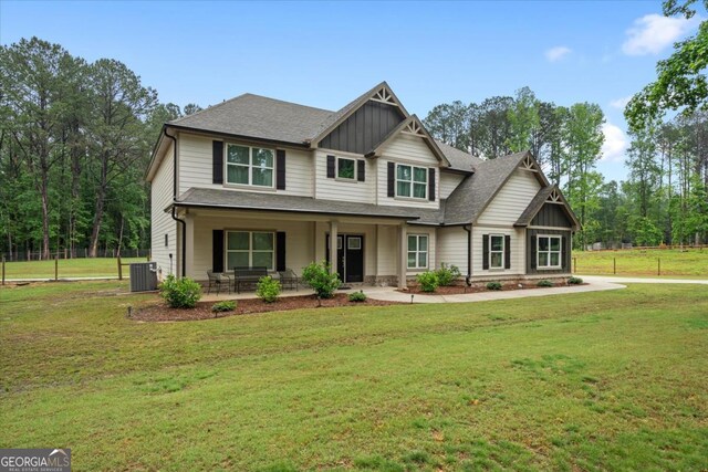 337 Paynes Lake Rd, Carrollton, GA 30116 - craftsman-style house with board and batten siding, cooling unit, a front lawn, a porch, and a shingled roof
