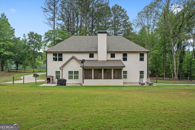 337 Paynes Lake Rd, Carrollton, GA 30116 - rear view of house featuring a patio, a sunroom, roof with shingles, and a chimney
