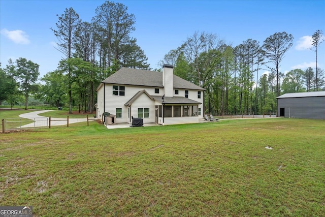 337 Paynes Lake Rd, Carrollton, GA 30116 - rear view of property with a sunroom, a chimney, a patio, and roof with shingles