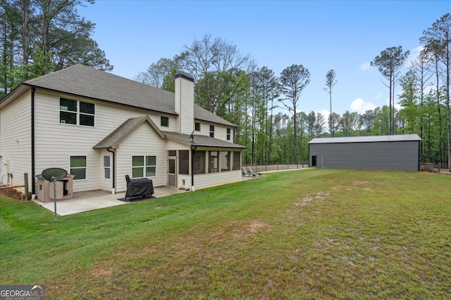 337 Paynes Lake Rd, Carrollton, GA 30116 - rear view of house featuring a sunroom, a chimney, a patio, and a shingled roof