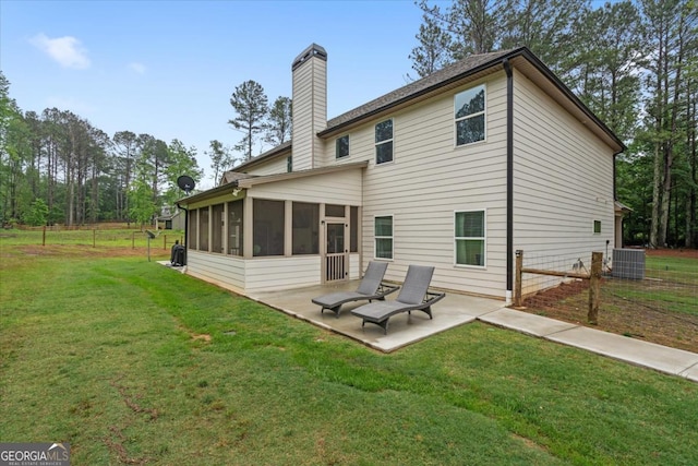 337 Paynes Lake Rd, Carrollton, GA 30116 - rear view of house featuring a patio area, a sunroom, central AC unit, and a chimney