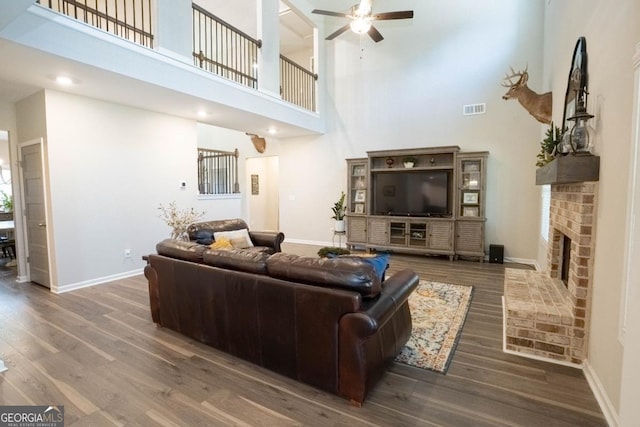 337 Paynes Lake Rd, Carrollton, GA 30116 - living room with ceiling fan, a high ceiling, wood finished floors, baseboards, and a fireplace