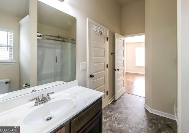 8744 Hamil Ct, Douglasville, GA 30135 - bathroom featuring healthy amount of natural light, vanity, toilet, and a shower with door