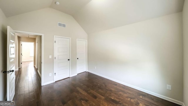 8744 Hamil Ct, Douglasville, GA 30135 - unfurnished bedroom with vaulted ceiling, attic access, dark wood-style flooring, and baseboards