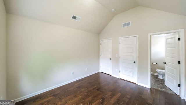 8744 Hamil Ct, Douglasville, GA 30135 - unfurnished bedroom with vaulted ceiling, dark wood-style floors, baseboards, and ensuite bathroom
