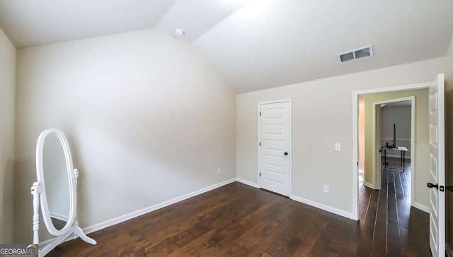 8744 Hamil Ct, Douglasville, GA 30135 - unfurnished bedroom featuring vaulted ceiling, dark wood finished floors, and baseboards