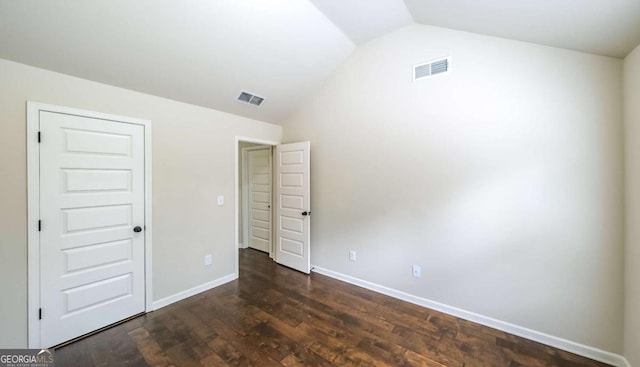 8744 Hamil Ct, Douglasville, GA 30135 - unfurnished bedroom with lofted ceiling, dark wood-style flooring, and baseboards