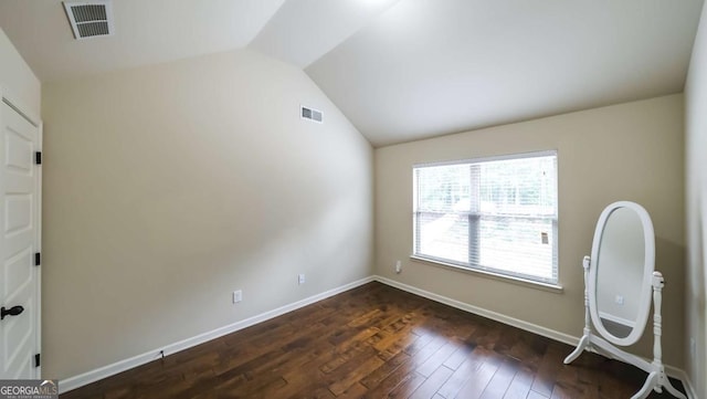 8744 Hamil Ct, Douglasville, GA 30135 - spare room featuring vaulted ceiling, dark wood finished floors, and baseboards