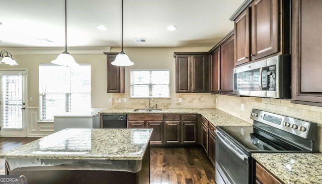 8744 Hamil Ct, Douglasville, GA 30135 - kitchen with appliances with stainless steel finishes, a sink, dark wood finished floors, light stone countertops, and wainscoting