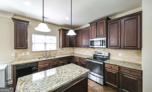 8744 Hamil Ct, Douglasville, GA 30135 - kitchen with appliances with stainless steel finishes, a sink, dark brown cabinets, light stone countertops, and recessed lighting