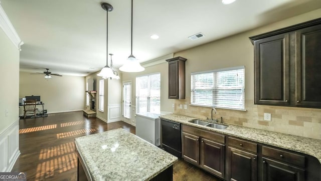 8744 Hamil Ct, Douglasville, GA 30135 - kitchen with a sink, black dishwasher, a kitchen island, backsplash, and light stone countertops