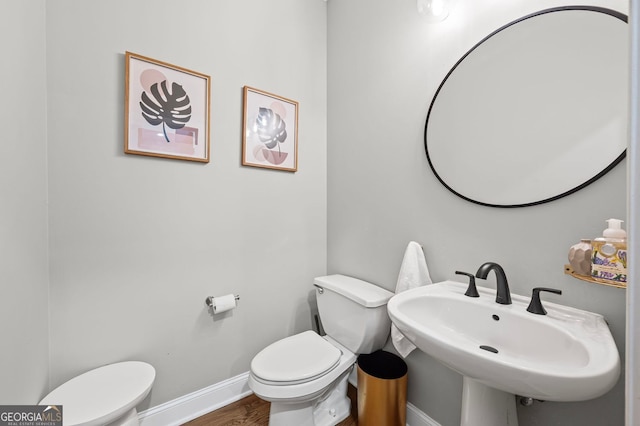 1308 NE Fernwood Cir NE, Atlanta, GA 30319 - half bath featuring toilet, baseboards, and wood finished floors