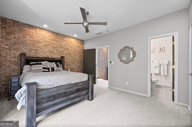 1308 NE Fernwood Cir NE, Atlanta, GA 30319 - carpeted bedroom with baseboards, recessed lighting, connected bathroom, ceiling fan, and brick wall