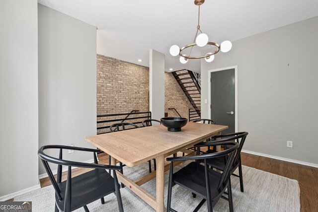 1308 NE Fernwood Cir NE, Atlanta, GA 30319 - dining area with brick wall, baseboards, a chandelier, stairway, and wood finished floors