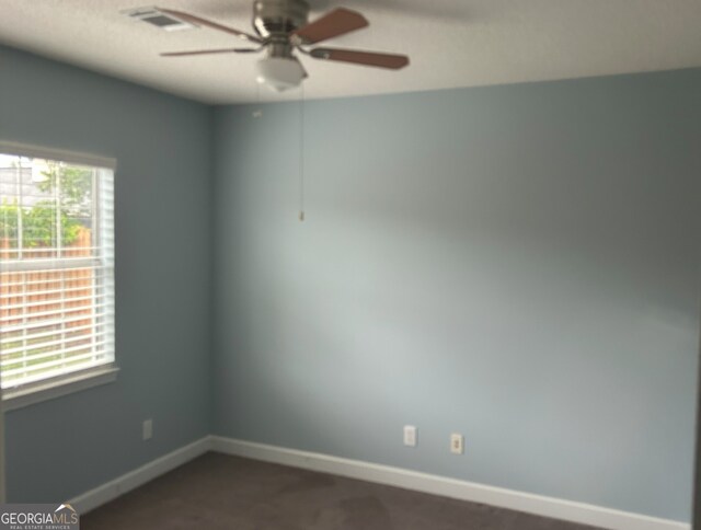 165 Woodgate Cir, Fayetteville, GA 30214 - spare room with ceiling fan, baseboards, and dark carpet