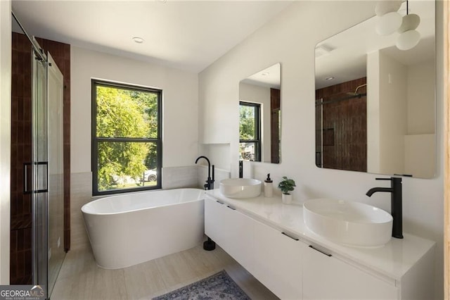 1130 Mclinden Ave SE, Smyrna, GA 30080 - bathroom with healthy amount of natural light, a freestanding bath, tile walls, and a shower stall