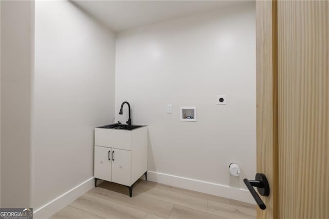 1130 Mclinden Ave SE, Smyrna, GA 30080 - washroom featuring hookup for an electric dryer, hookup for a washing machine, baseboards, and light wood-style floors
