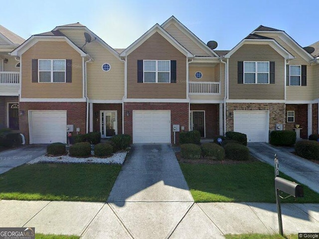 2148 Hasel St, Lawrenceville, GA 30044 - view of property with a garage, driveway, a front yard, and brick siding
