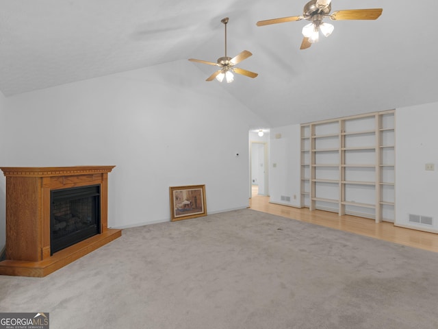 114 Overlook Dr, Mcdonough, GA 30252 - unfurnished living room with high vaulted ceiling, ceiling fan, carpet floors, a fireplace with raised hearth, and baseboards
