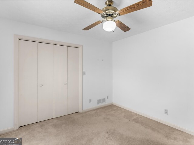 114 Overlook Dr, Mcdonough, GA 30252 - unfurnished bedroom featuring light carpet, baseboards, a closet, and a ceiling fan