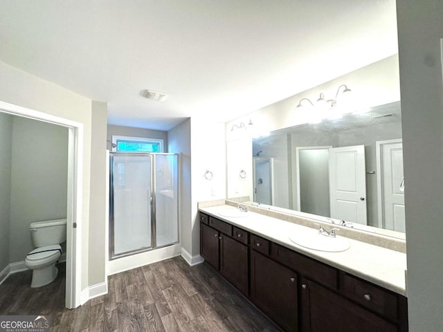 364 Dublin Way, Dallas, GA 30132 - bathroom featuring wood finished floors, double vanity, a shower stall, toilet, and baseboards