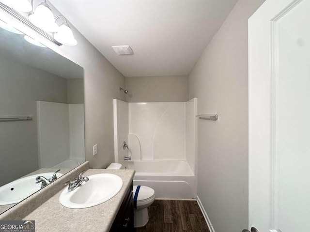 364 Dublin Way, Dallas, GA 30132 - bathroom with toilet, vanity, wood finished floors, shower / tub combination, and baseboards