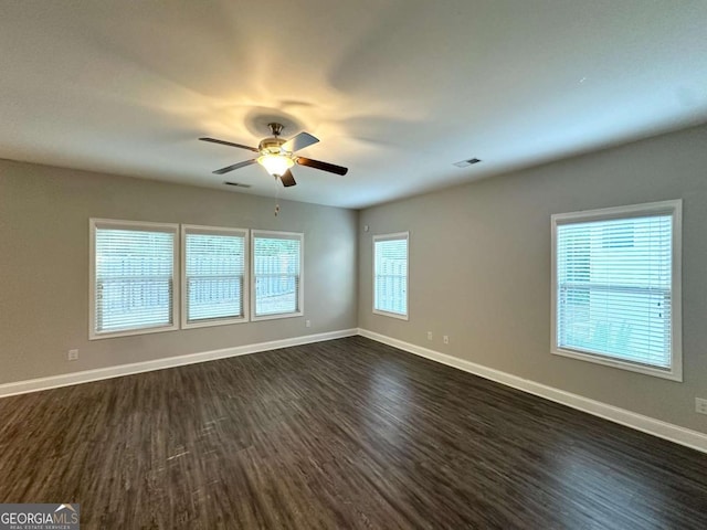 364 Dublin Way, Dallas, GA 30132 - empty room featuring dark wood-type flooring, a ceiling fan, healthy amount of natural light, and baseboards