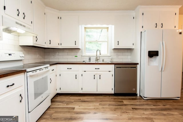 215 Cooper Rd, Athens, GA 30605 - kitchen with white appliances, under cabinet range hood, a sink, dark countertops, and white cabinets
