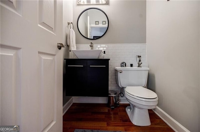 3620 Chartwell Dr, Suwanee, GA 30024 - half bathroom with toilet, vanity, wood finished floors, tile walls, and a wainscoted wall