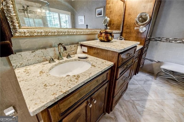 3620 Chartwell Dr, Suwanee, GA 30024 - bathroom with tile walls, vanity, wainscoting, marble finish flooring, and a bathtub