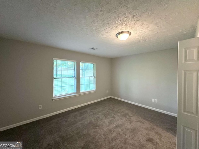 3170 W Point Cir, Douglasville, GA 30135 - unfurnished room featuring baseboards, dark carpet, and a textured ceiling