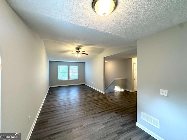 3170 W Point Cir, Douglasville, GA 30135 - spare room with a textured ceiling, baseboards, dark wood finished floors, ceiling fan, and lofted ceiling