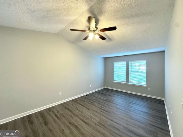 3170 W Point Cir, Douglasville, GA 30135 - spare room featuring a textured ceiling, dark wood-style floors, ceiling fan, baseboards, and lofted ceiling